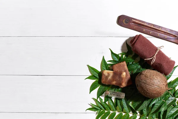 Kahverengi havlu, mavi kil ve doğal kahve soap üzerinde beyaz ahşap masa, üstten görünüm
