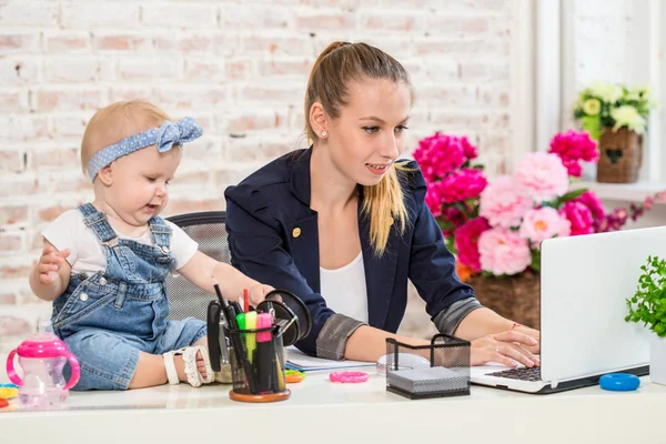 Mulher de negócios mãe mulher com uma filha trabalhando no laptop — Fotografia de Stock