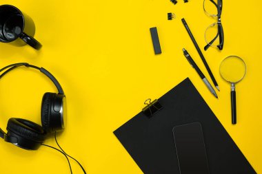 Office sarı bir arka plan üzerinde siyah nesnelerden. İş ve yaratıcılık. Üstten Görünüm.