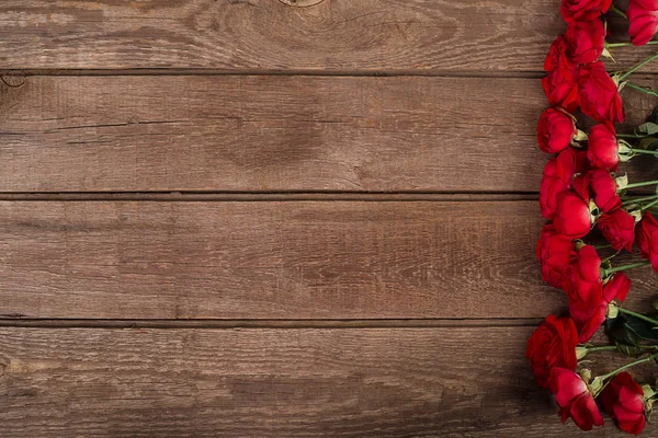 Rode rozen boeket over houten tafel. Bovenaanzicht met kopie ruimte. bloemen — Stockfoto