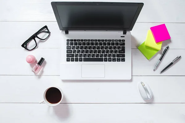 Workspace with laptop, green flower in a pot, mint diary on white background.