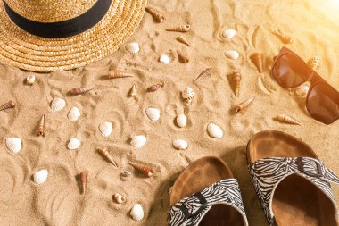 Beachwear, flip flop, şapka, güneş gözlüğü ve kabukları üzerinde kum plaj yaz.