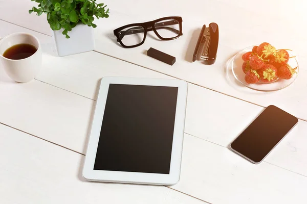 Flower pot, glasses, tablet, smart on white desktop