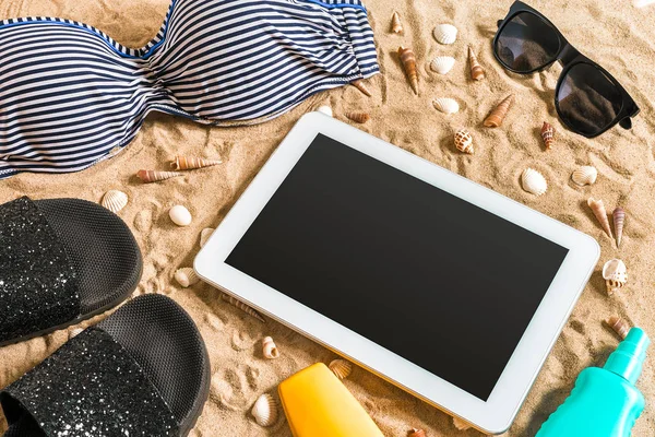 Summer bikini and accessories stylish beach set, Beach bikini summer outfit and sea sand as background, Top View, Concept