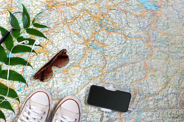 Travel plan, trip vacation accessories for trip, tourism mockup - Outfit of traveler on map background. Flat lay and copyspace.