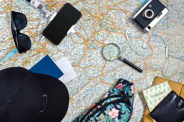 Travel plan, trip vacation accessories for trip, tourism mockup - Outfit of traveler on map background. Flat lay and copyspace.