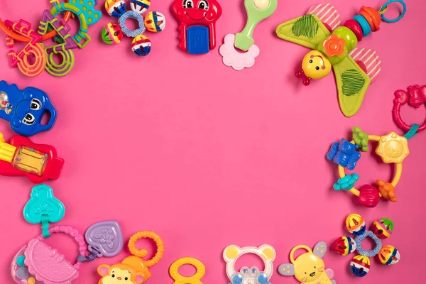 Childrens rattle from plastic on a pink background. Top view — Stock Photo, Image