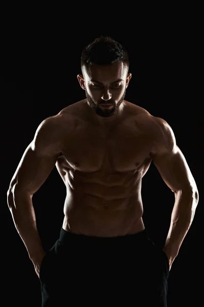 Very muscular man posing with naked torso in studio — Stock Photo, Image