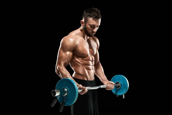 Muscular man lifting weights over dark background — Stock Photo, Image