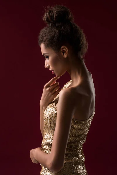 Fashion young African woman with make-up, in sexy gold dress. — Stock Photo, Image