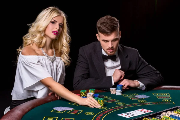 couple playing poker at the table.