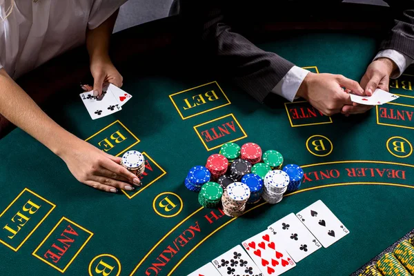 couple playing poker at the table