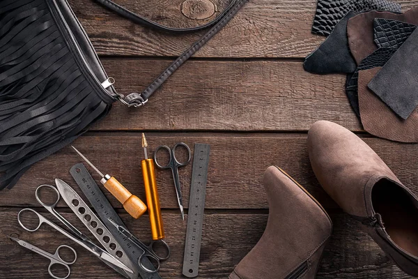 Leather craft or leather working. Leather working tools and cut out pieces of leather on work desk .