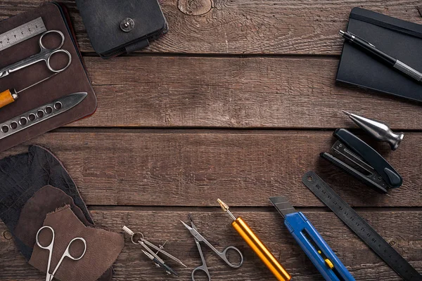 Leather handbag. Work place craftsman in a workshop. Top view