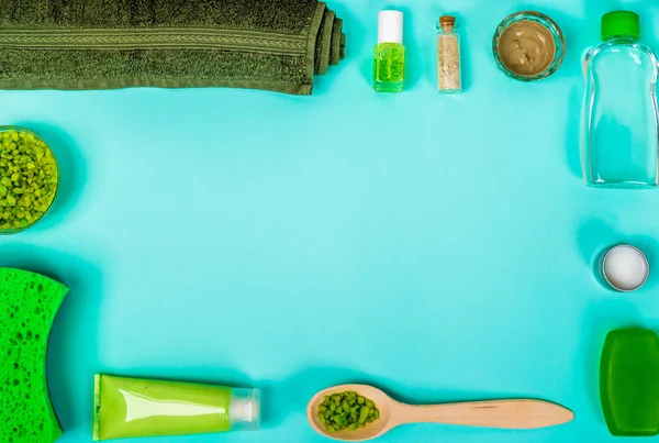 Spa set: soap, mask, oil, sea salt and towel on blue background — Stock Photo, Image