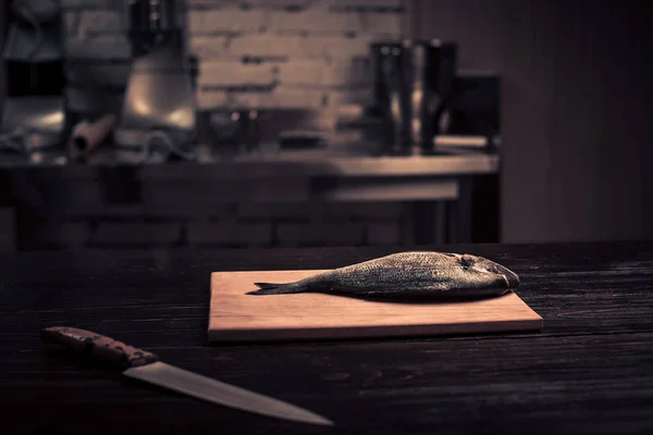 Frischer Fisch auf einem Holzschneidebrett — Stockfoto