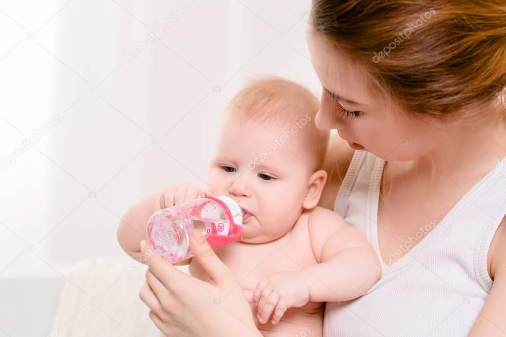 Feeding Baby. Baby eating milk from the bottle.