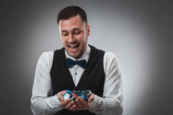 Poker player taking poker chips after winning