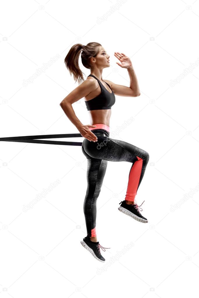 Woman exercising fitness resistance bands in studio silhouette isolated on white background