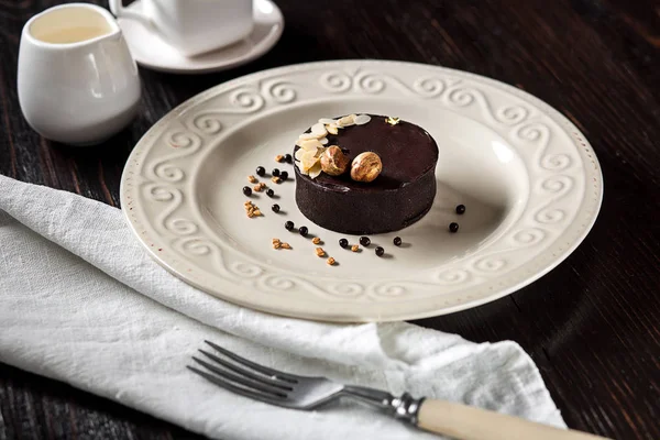 Güzel dekore edilmiş altın fındık ve bir fincan kahve ile çikolatalı kek