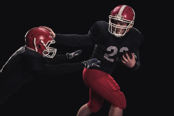 Football player on dark background — Stock Photo, Image