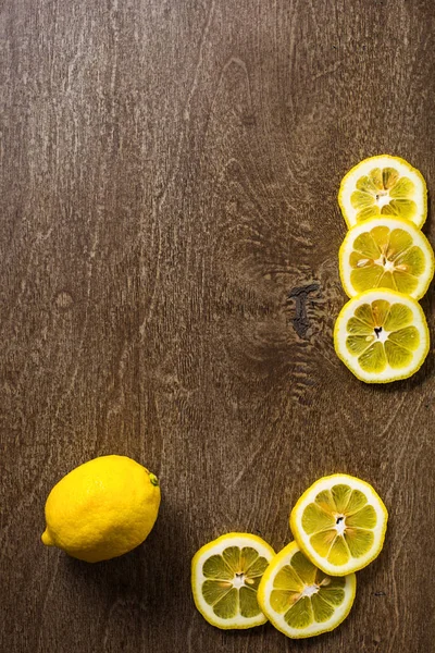 sliced lemon, lime on  slate and wooden counter top background