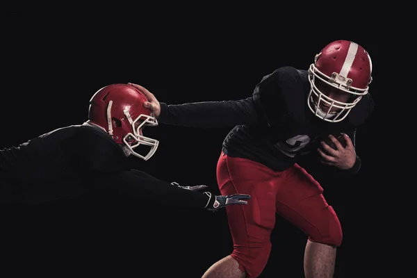 Football player on dark background — Stock Photo, Image