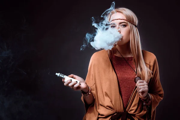 Young woman in the Boho style blowing smoke — Stock Photo, Image