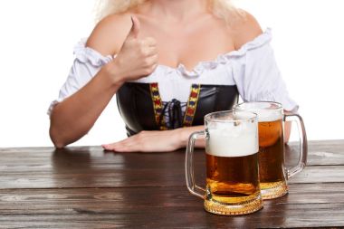 Oktoberfest bira stein dışında geleneksel kostüm güzel genç sarışın kız içecekler.