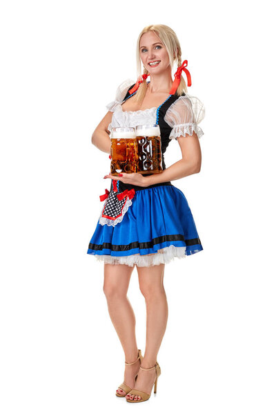 Full length portrait of a blond woman with traditional costume holding beer glasses isolated on white background