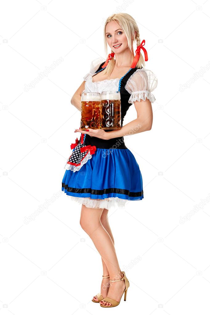 Full length portrait of a blond woman with traditional costume holding beer glasses isolated on white background.