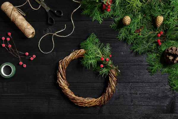 Fabricante de decoração de Natal com suas próprias mãos. Grinalda de Natal para o feriado. A celebração do ano novo. Vista superior — Fotografia de Stock