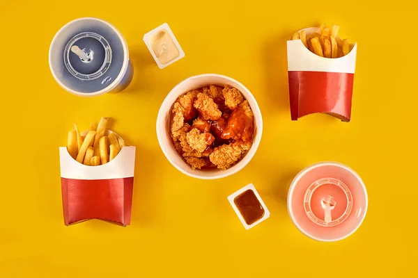 Fast food dish on yellow background. Fast food set fried chicken and french fries. Take away fast food. — Stock Photo, Image
