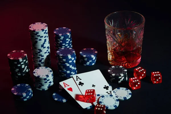 Poker cards with cubes are beautifully placed on the table, against the background of poker chips