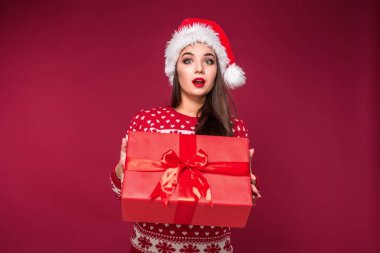 Noel hediyesi ellerinde kırmızı studio arka planda tutan genç güzel kadın