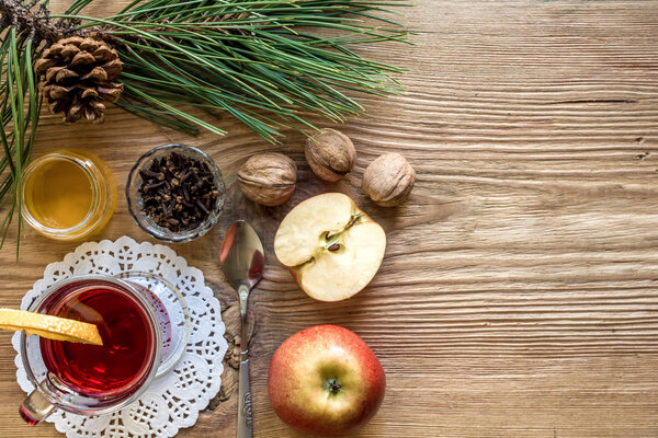 Mulled wine with spices on wooden background