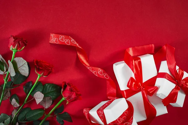Frisk, rød roseblomst og gaveboks på rød dekk med emp. – stockfoto