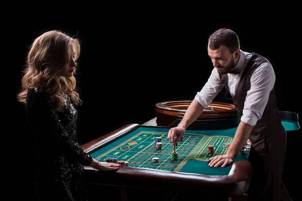 Croupier en vrouw speler aan een tafel in een casino. Foto van een c — Stockfoto