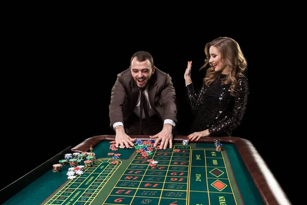 Man with woman playing roulette at the casino. Addiction to the — Stock Photo, Image