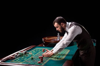Croupier behind gambling table in a casino. clipart
