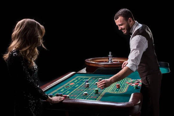 Croupier and woman player at a table in a casino. Picture of a c