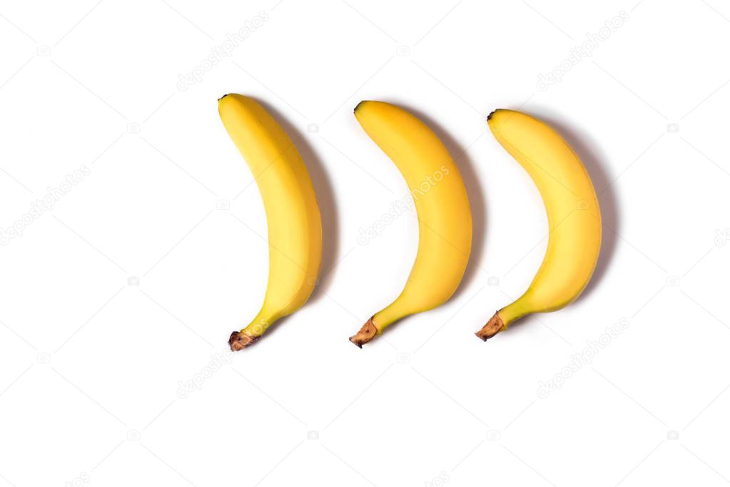 Ripe yellow bananas on a white background