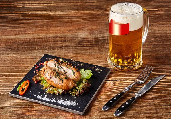 Grillwürste mit Bier auf Holztisch. Ansicht von oben. — Stockfoto