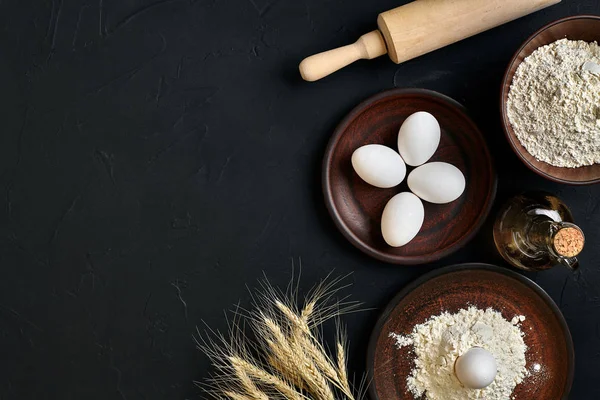 Preparation cooking baking kitchen table brown dishes ware fresh grocery different ingredients: eggs, flour, oil, stuff top view