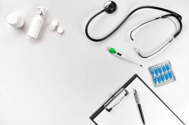 Stetoskop doktor ofisinde. Üstten Görünüm doktorlar Resepsiyon tablo, boş kağıt kalem ile Pano üzerinde. Uzay kopyalayın. Tasarımcılar boş