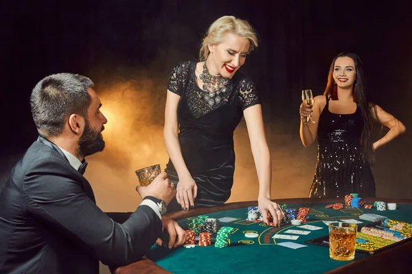 Group of young rich people is playing poker in the casino — Stock Photo, Image