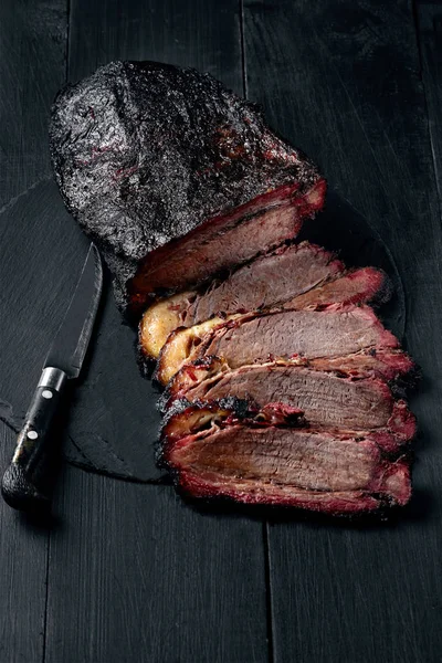 Brisket fresco churrasco carne fatiada para servir contra um fundo escuro — Fotografia de Stock