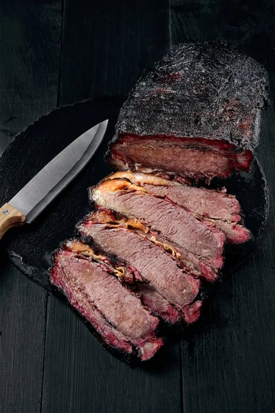 Fresh Brisket BBQ beef sliced for serving against a dark background — Stock Photo, Image