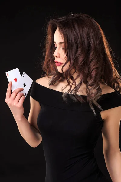 Young woman playing in the gambling on black background — Stock Photo, Image