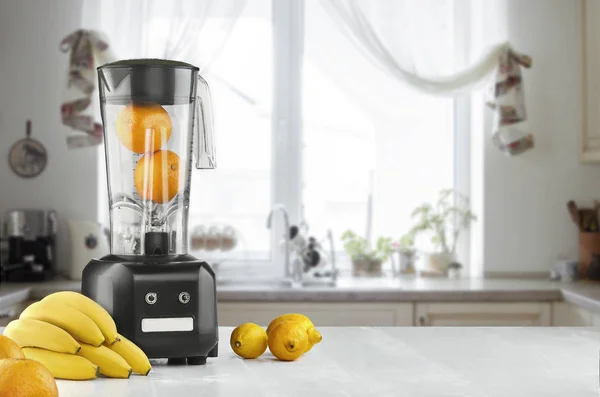 Metal food blender close-up with fresh exotic tropic fruits next to it on kitchen background with empty space — Stock Photo, Image